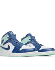 A pair of Nike Air Jordan 1 Mid Mystic Navy sneakers in blue and mint