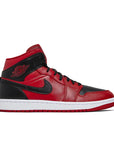 Side of Nike Air Jordan 1 Mid Reverse Bred baskteball shoes in black and red