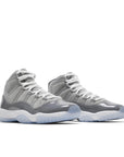 A pair of grade school kids Nike Air Jordan 11 cool grey basketball shoes in grey and white