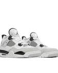 A pair of grade school kids Nike Air Jordan 4 military black basketball shoes in white and black