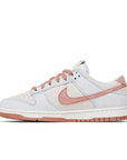 Side of the Nike dunk low fossil rose skating shoes in rose and grey
