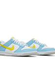 A pair of gradeshool Nike Dunk Low Next Nature Homer Simpson GS childrens sneakers in white, blue and yellow