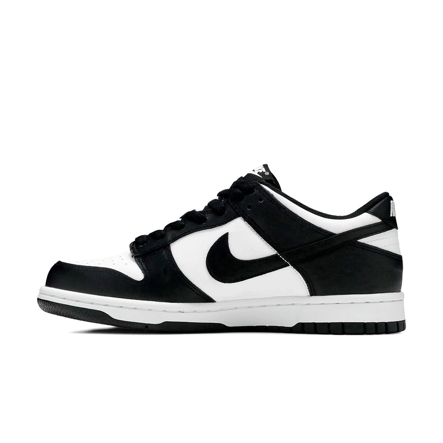 Side of the youth version of the Nike dunk low in a black white "Panda" colour