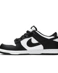 Side of the childrens version of the Nike dunk low in a black white "Panda" colour