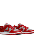 A pair of the Nike dunk low retro in a grey red unlv colour
