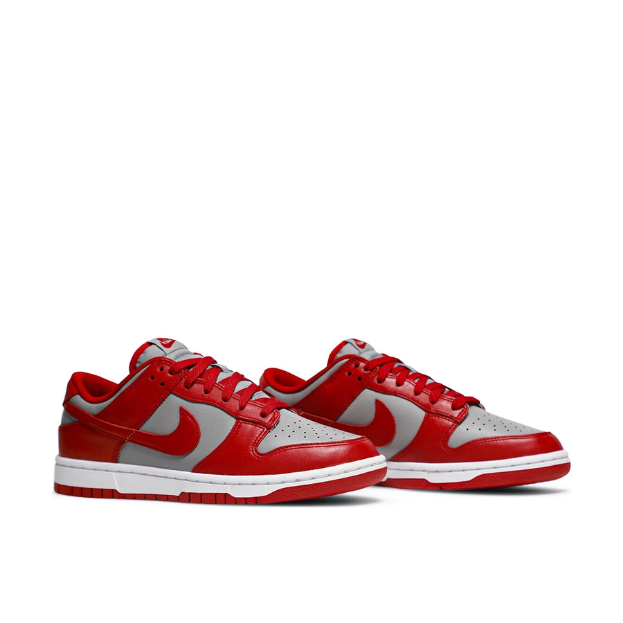 A pair of the Nike dunk low retro in a grey red unlv colour
