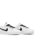 A pair of Nike Dunk Low Reverse Panda basketball shoes in white and black