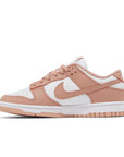 Side of the womens Nike dunk low in a white peach "rose whisper" colour