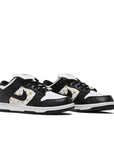 A pair of the Nike dunk supreme low skating shoes in a gold stars white black colour