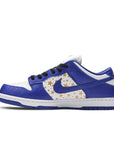 Side of the Nike dunk supreme low skating shoes in a gold stars white blue hyper royal colour