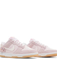 Pair of Nike Dunk Low Teddy Bear (W) in soft pink and white.