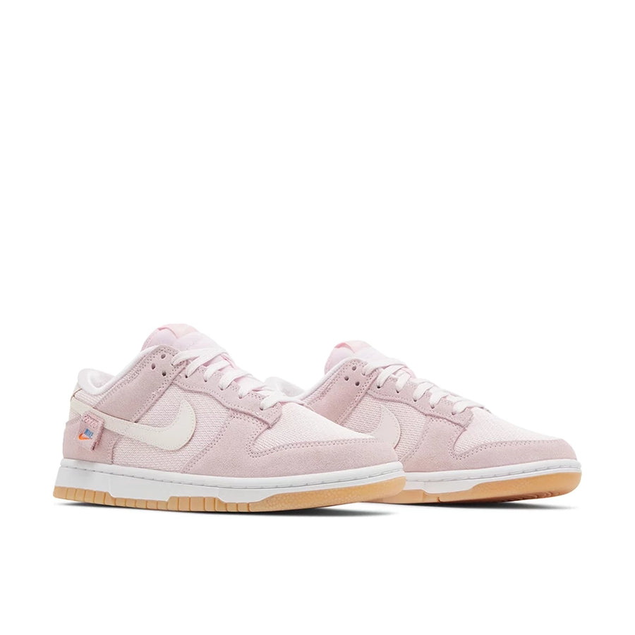 Pair of Nike Dunk Low Teddy Bear (W) in soft pink and white.