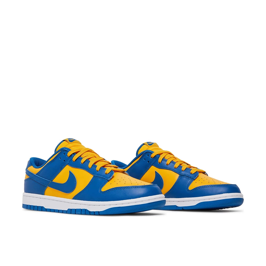 A pair of the Nike dunk lows in a yellow blue "ucla" colour