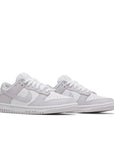 A pair of the womens Nike dunk lows in a white lilac "venice" colour