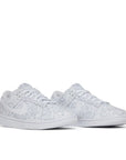 A pair of Nike Dunk Low White Paisley womens sneakers in white and grey paisley
