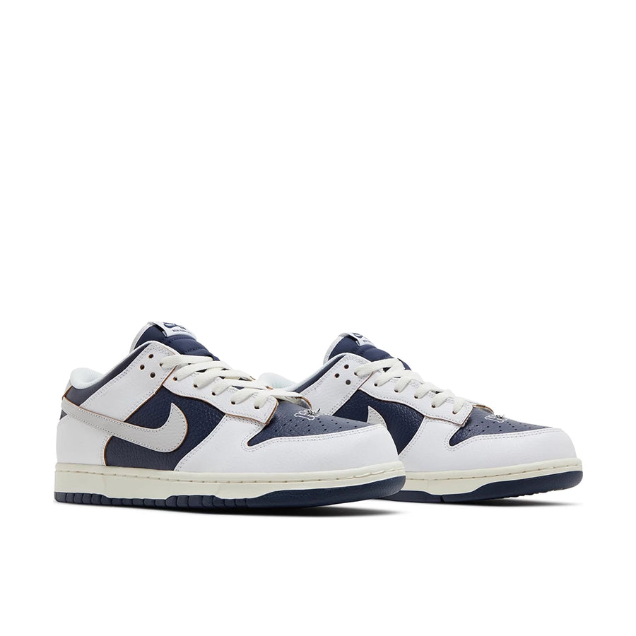Pair of Nike SB Low HUF New York in navy and white.