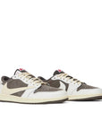 A pair of Nike Air Jordan 1 Low OG SP Travis Scott Reverse Mocha exclusive sneakers in white, mocha and brown