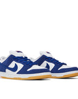 A pair of the Nike sb dunk low los angeles dodgers skating shoes in white and blue