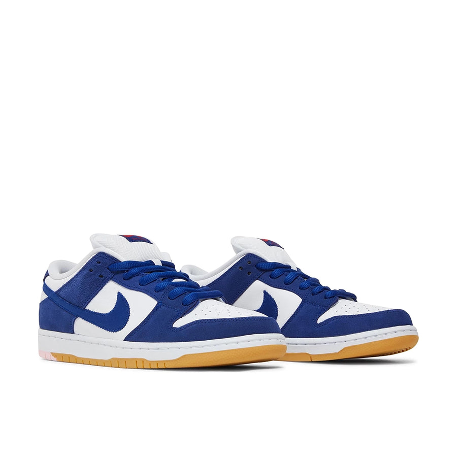 A pair of the Nike sb dunk low los angeles dodgers skating shoes in white and blue