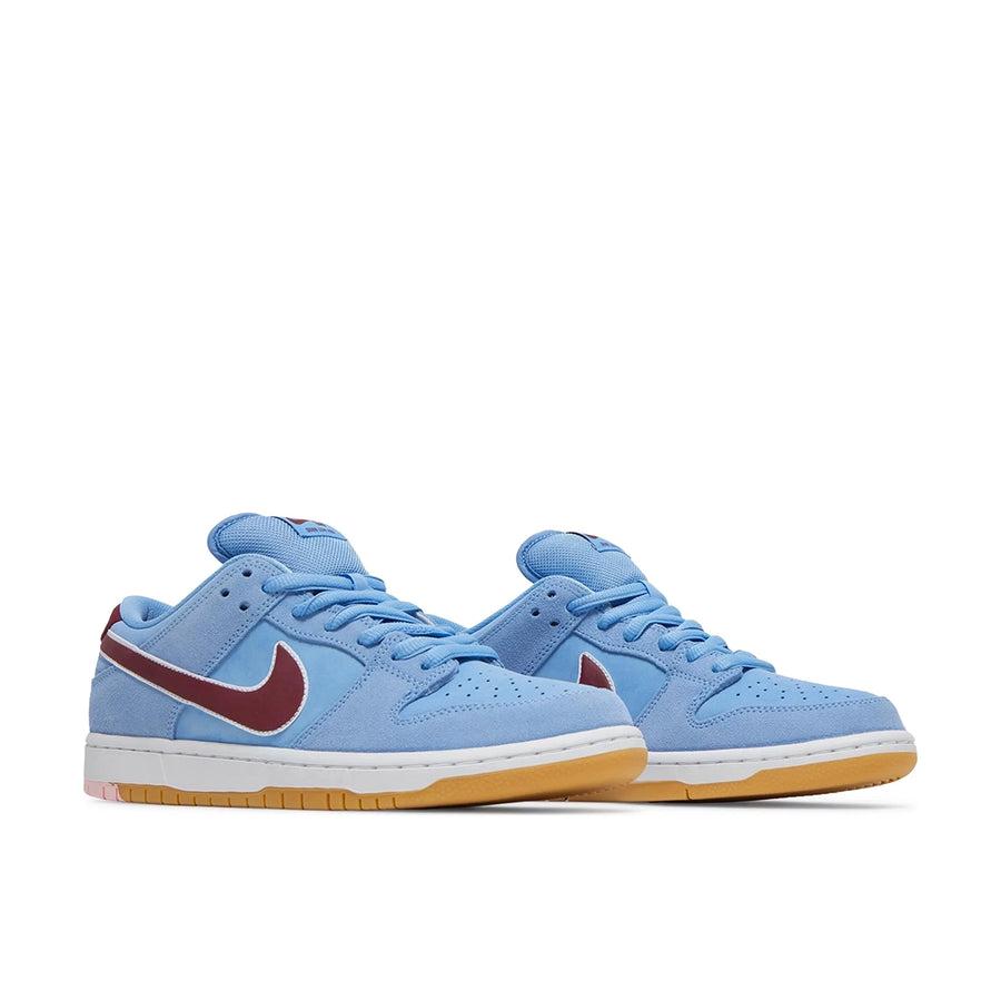 A pair of Nike SB Dunk Low Valour Blue Team Maroon skating shoes in blue and burgundy