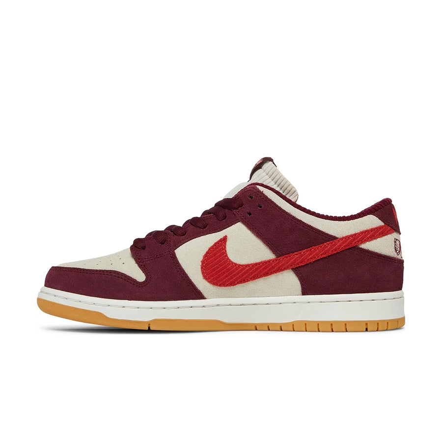 Side of the Nike sb dunk low pro skate like a girl skating shoes in burgundy and cream